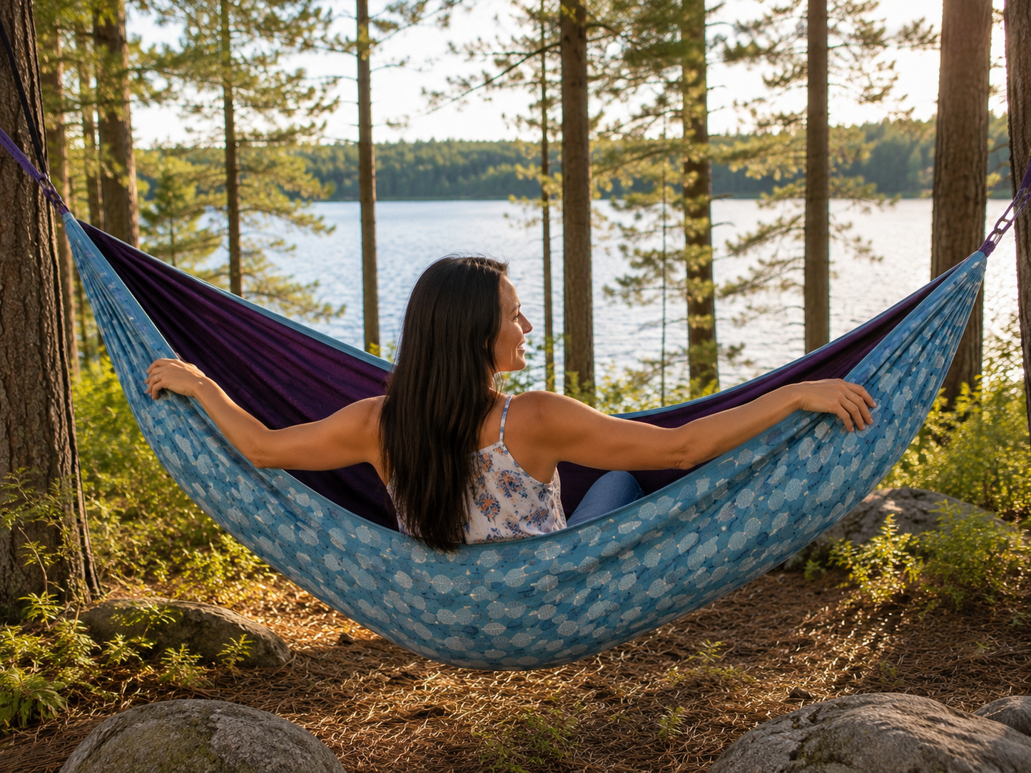 Rear lakeside view of Kathy enjoying the Azure Solstice hammock