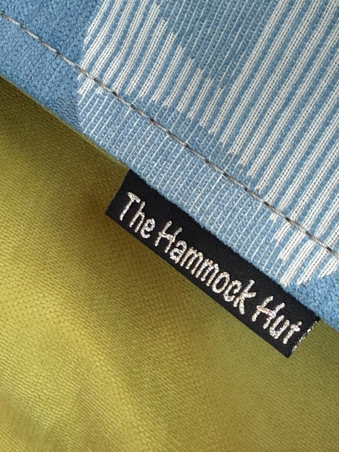 Close-up of Fernwater Solstice Premium Hammock fabric, stitching, and The Hammock Hut label
