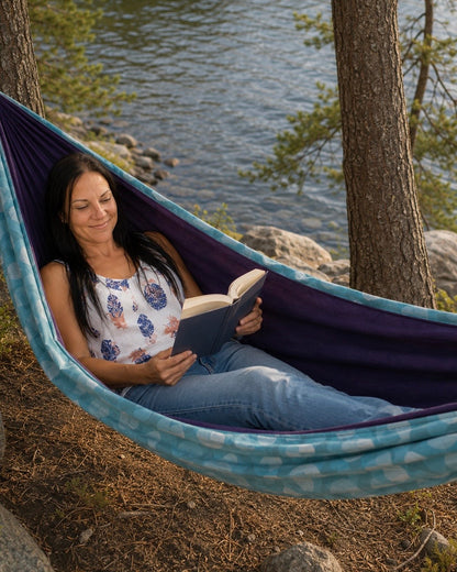 Close view of the Azure Solstice hammock with lake and trees behind