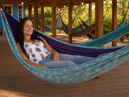 Kathy reclining in the Azure Solstice hammock under the Hammock Hut shelter