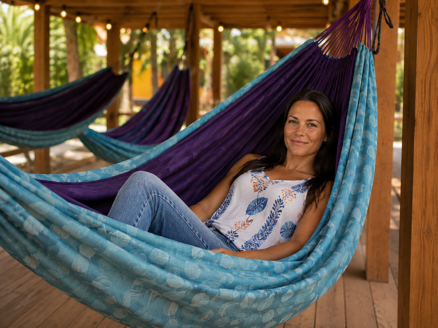 Kathy relaxing in the Azure Solstice hammock with other hammocks in the Hut behind her