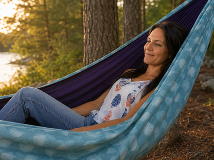 Close view of Kathy relaxing in the Azure Solstice hammock beside the lake