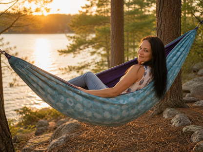 Kathy relaxing in the Azure Solstice hammock beside the lake at sunset