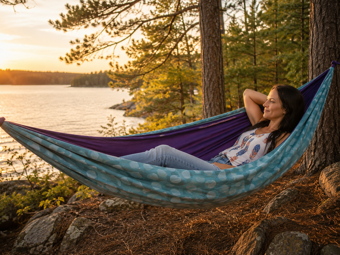 Kathy reclining in the Azure Solstice hammock in warm lakeside evening light