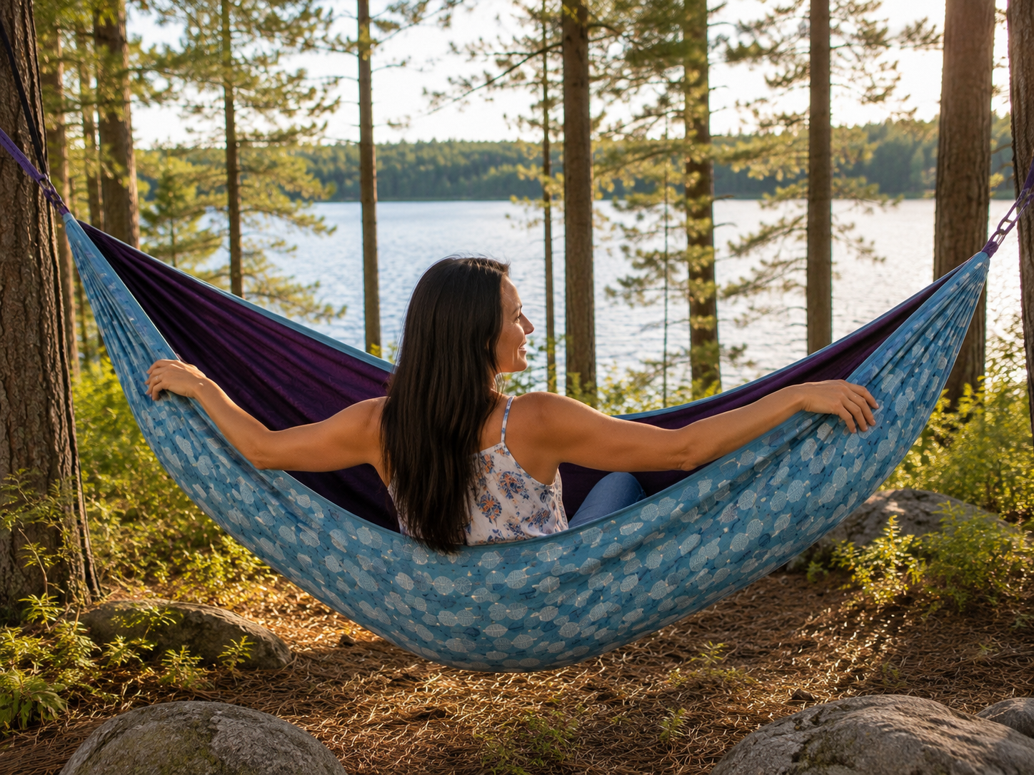 Rear lakeside view of Kathy enjoying the Azure Solstice hammock