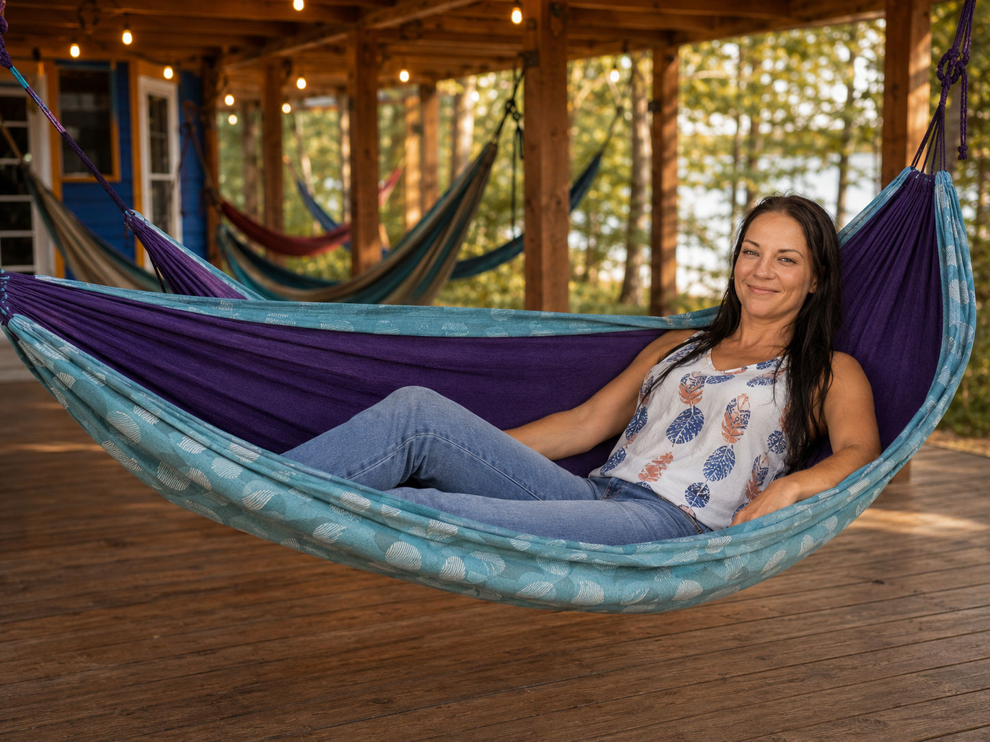 Kathy smiling in the Azure Solstice hammock under the Hammock Hut shelter