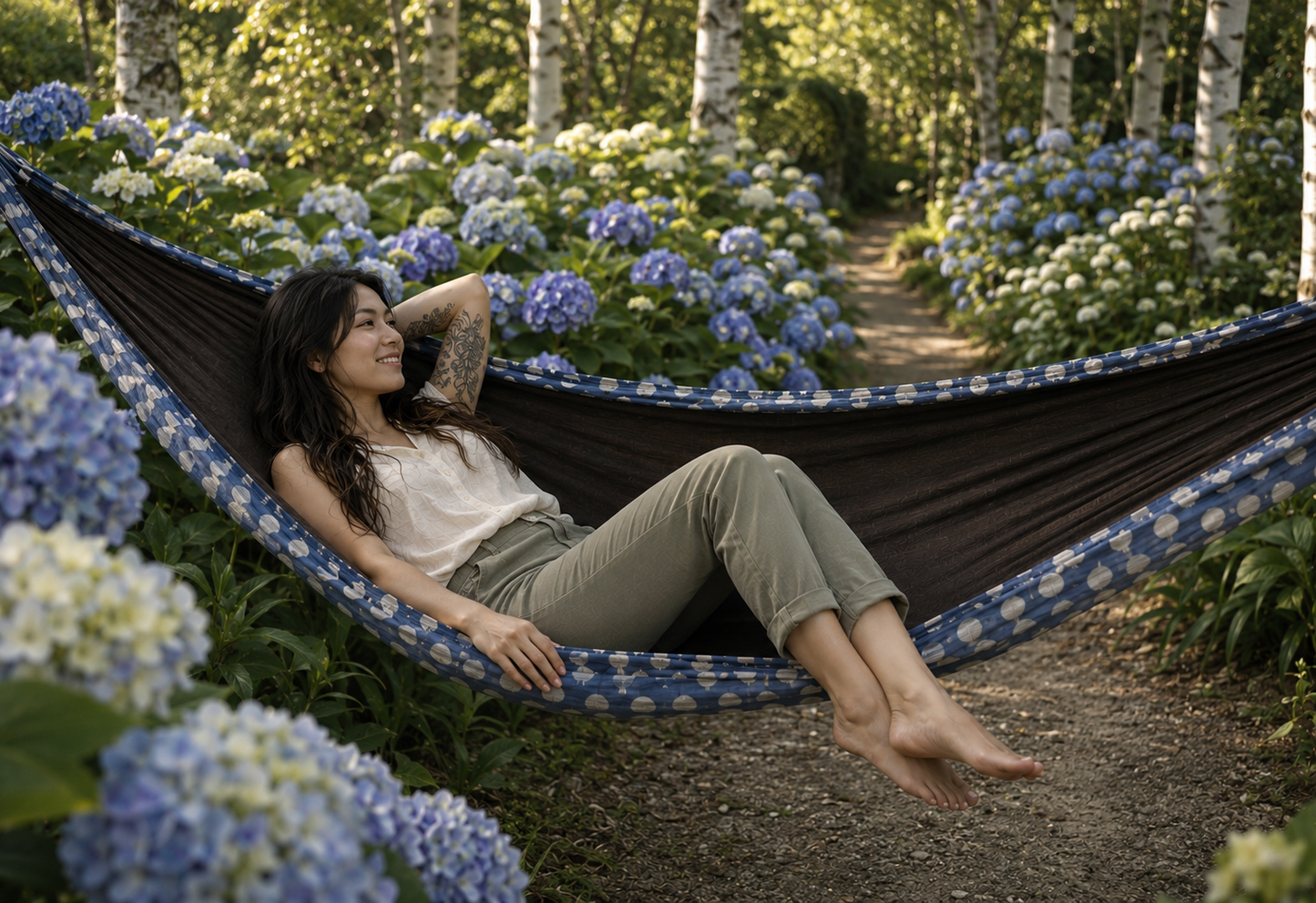 Botanica Solstice Premium Hammock along a blooming birch garden path