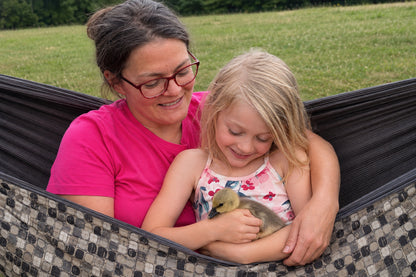 Mother and daughter cuddling a gosling in Chocoholic Premium Hammock