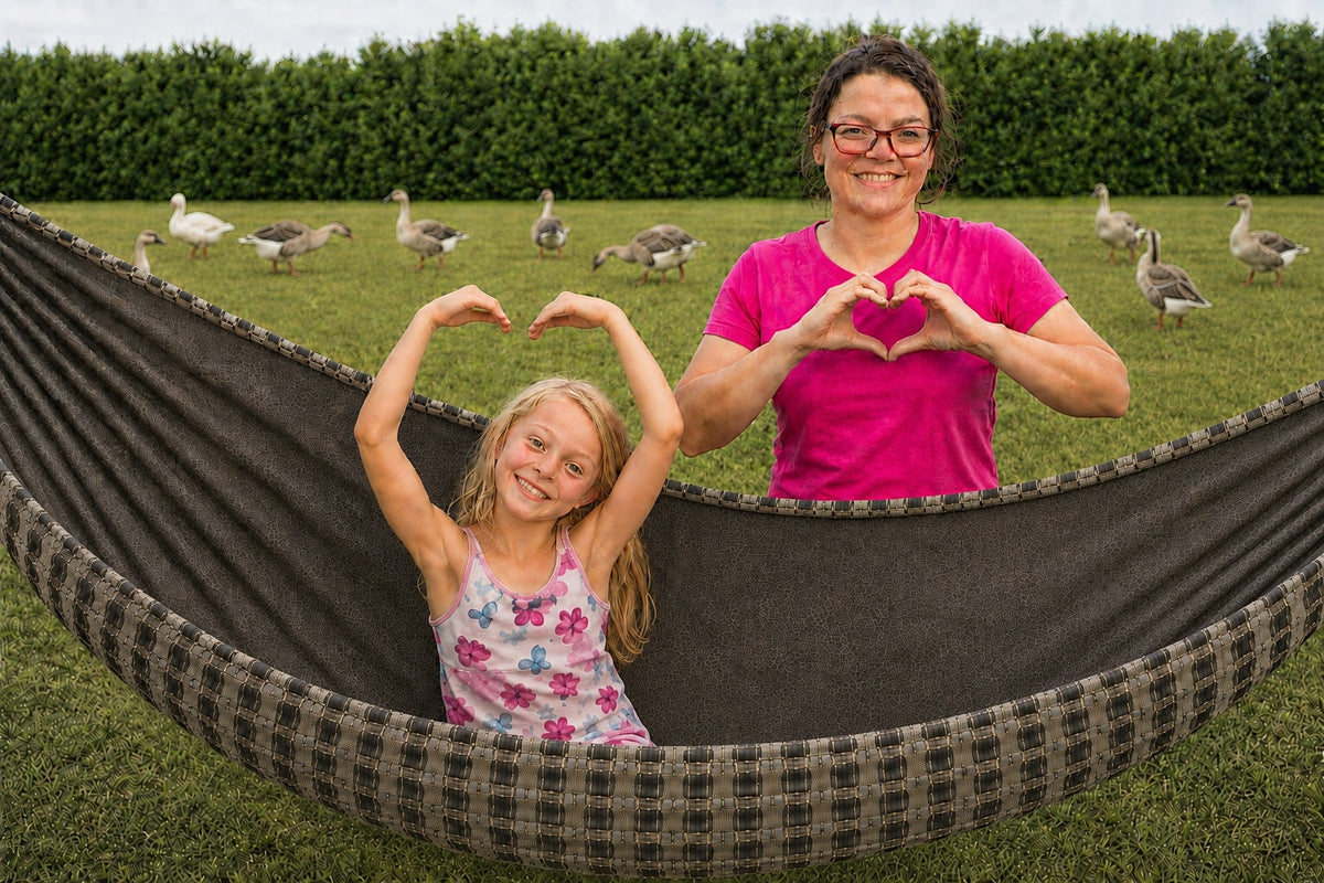 Mother and daughter making heart shapes beside Chocoholic Premium Hammock