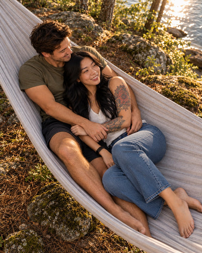 Overhead view of two adults relaxing in the extra-wide Concrete + Premium Hammock