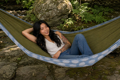 Woman reclining and smiling in Fernwater Solstice Premium Hammock