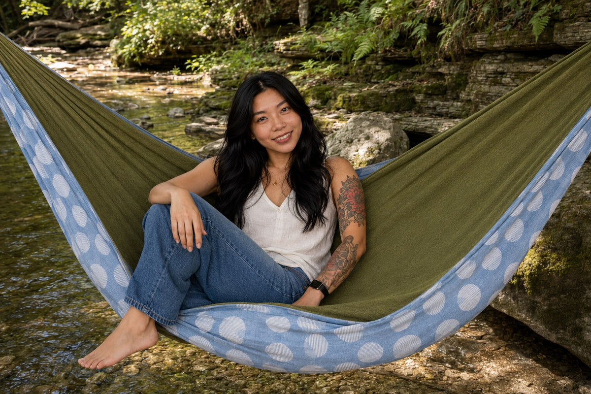 Woman seated comfortably in Fernwater Solstice Premium Hammock