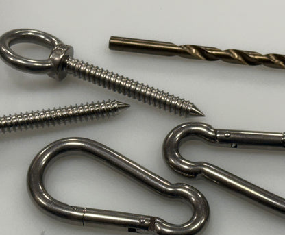 Close-up of stainless steel eye screw threads, carabiner and pilot bit