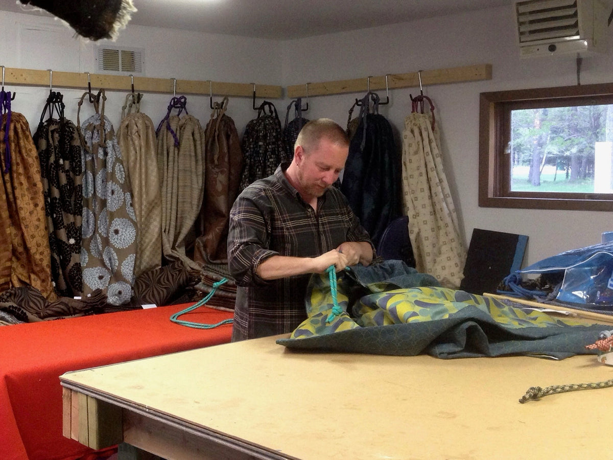 A Hammock Hut hammock being hand-finished at the worktable.
