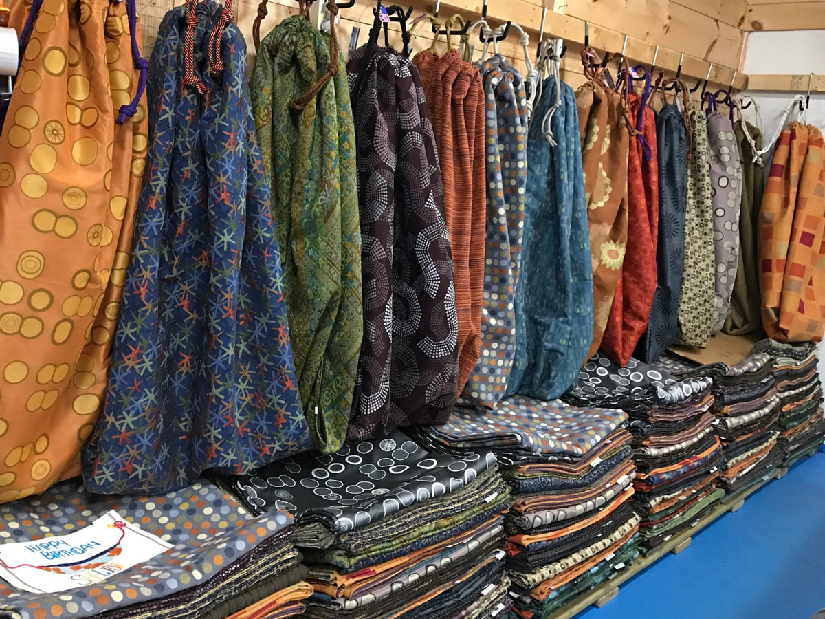 Rows of colorful handmade Hammock Hut hammocks displayed inside the shop.