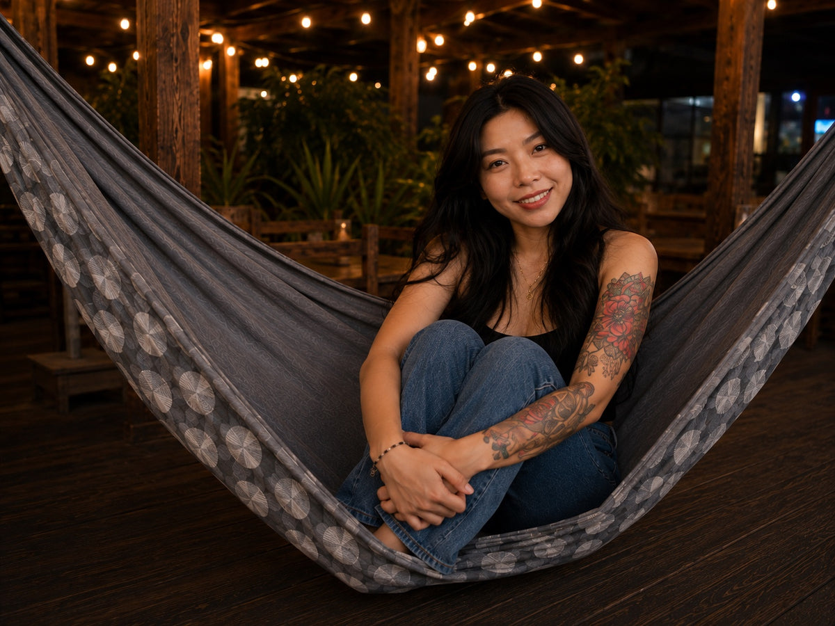 Moonstone Solstice Premium Hammock with model sitting comfortably with her knees tucked in