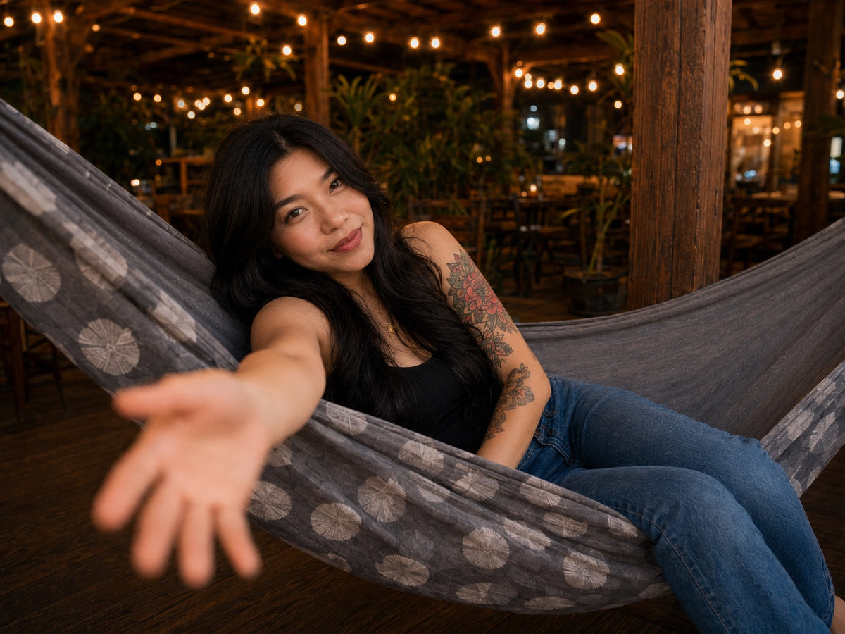 Moonstone Solstice Premium Hammock playful lifestyle photo with model reaching toward the camera