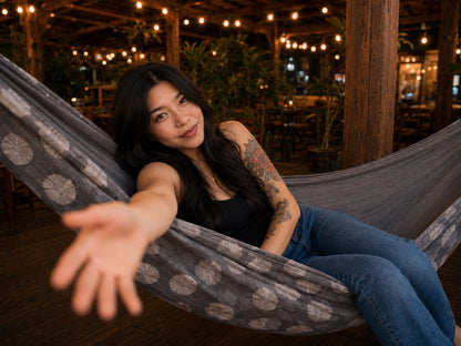 Moonstone Solstice Premium Hammock playful lifestyle photo with model reaching toward the camera