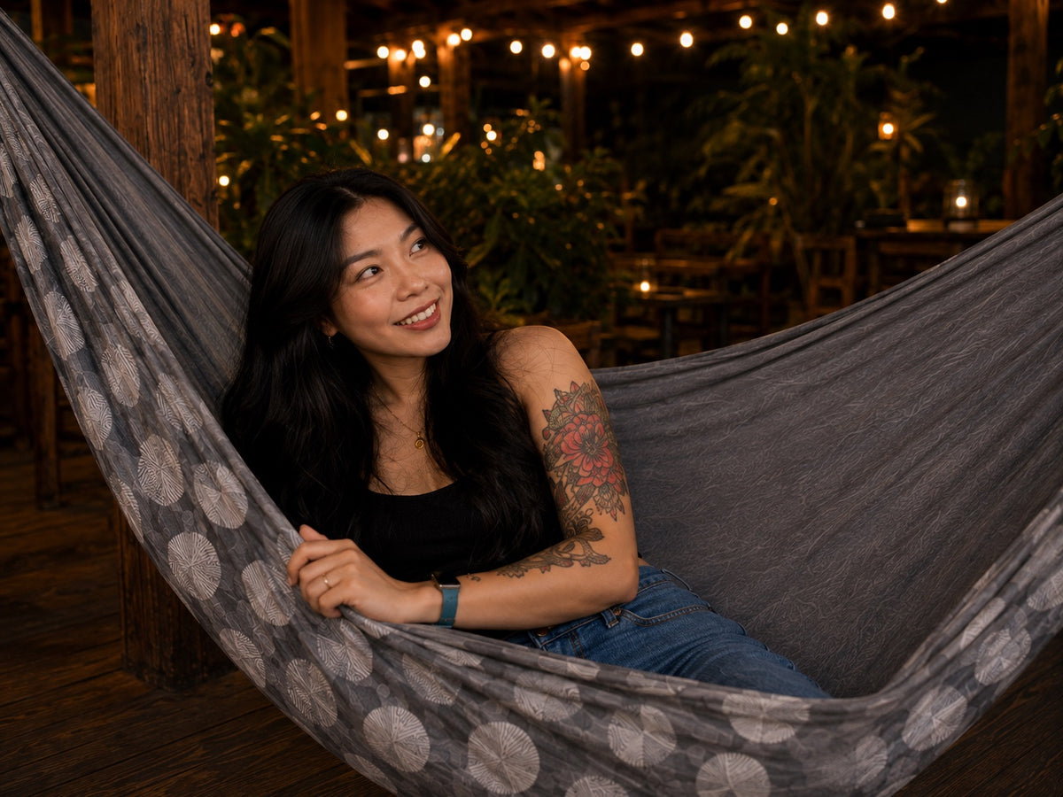 Moonstone Solstice Premium Hammock lifestyle portrait with model leaning comfortably in the hammock