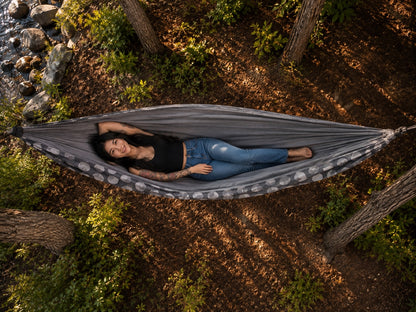 Aerial overhead view of the Moonstone Solstice Premium Hammock with model relaxing among trees