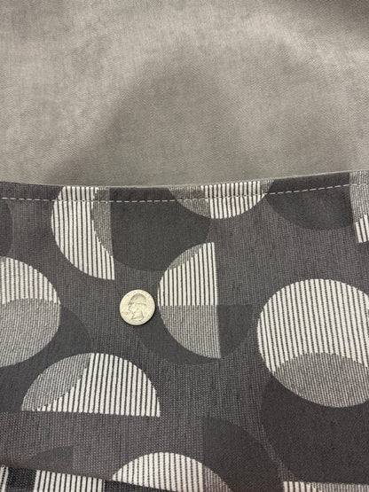 Close-up of Moonstone Solstice charcoal patterned exterior and soft gray interior fabric with quarter for scale