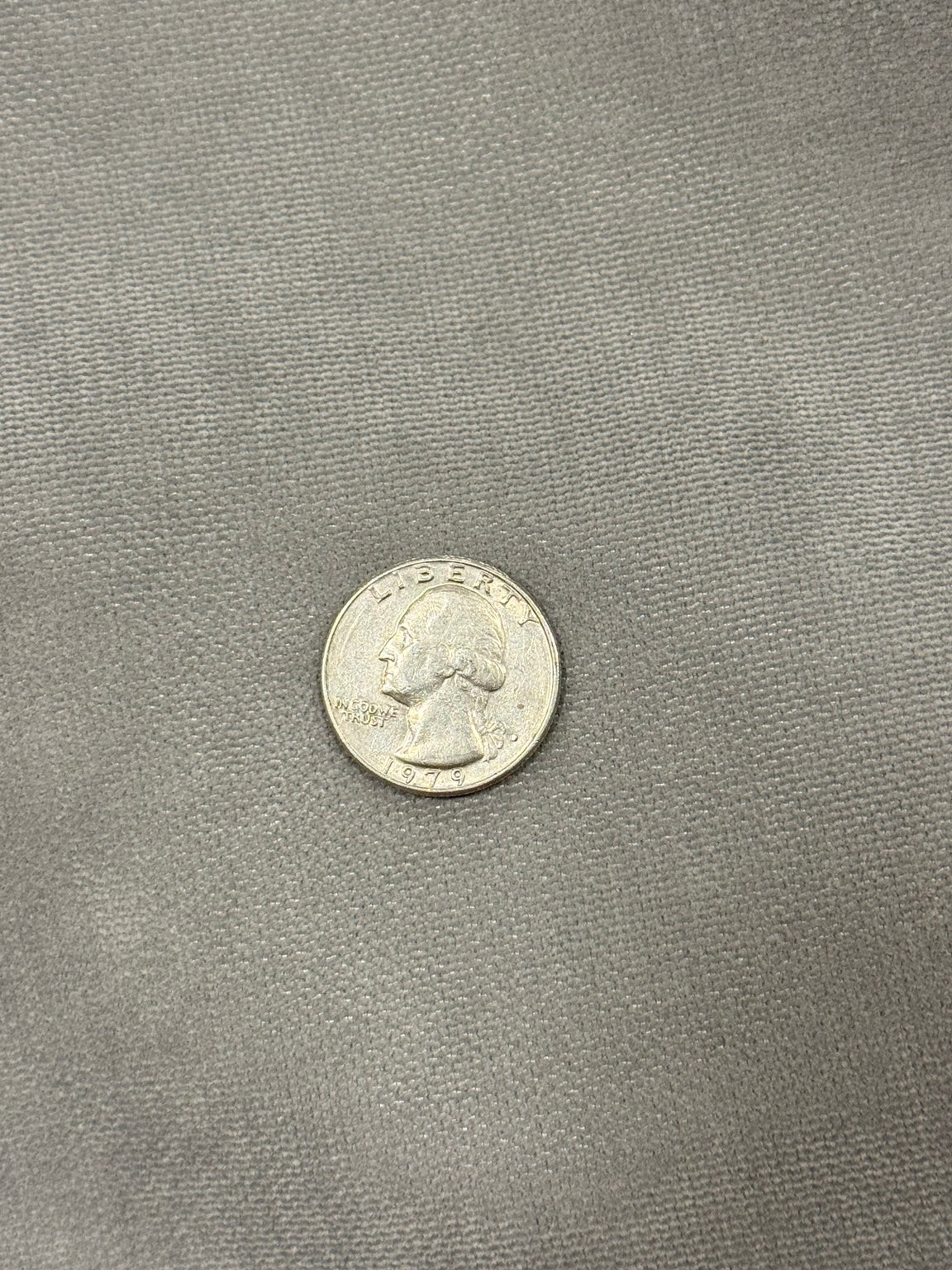 Close-up of the soft gray Moonstone Solstice interior fabric with quarter for scale