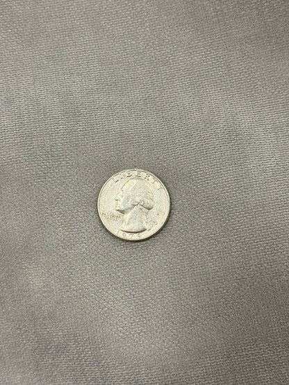 Close-up of the soft gray Moonstone Solstice interior fabric with quarter for scale
