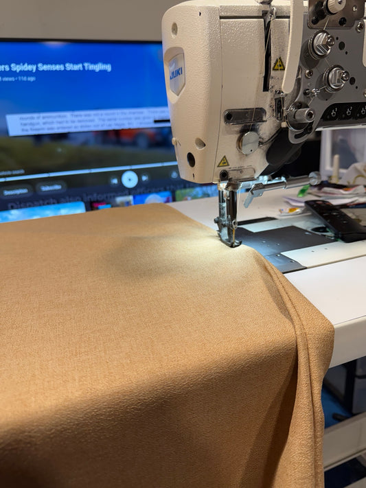 Sandbox premium hammock fabric being sewn with sand-colored thread