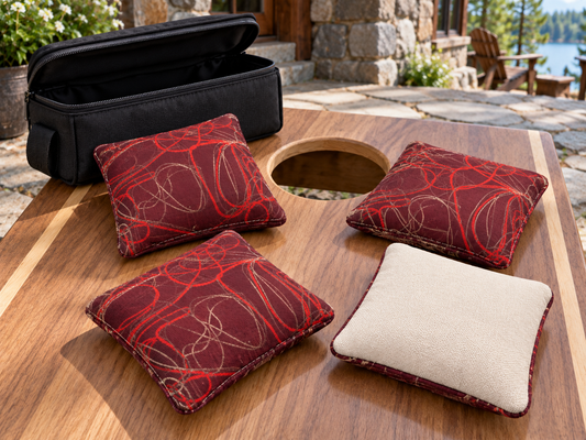 Four Premium Scribble Firecracker Red cornhole bags with cream Maglite reverse and black carrying case