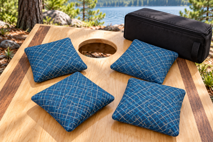 Four Spark Flow Blue Sky cornhole bags with matching patterned faces and black carrying case
