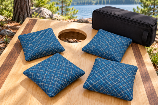 Four Spark Flow Blue Sky cornhole bags with matching patterned faces and black carrying case