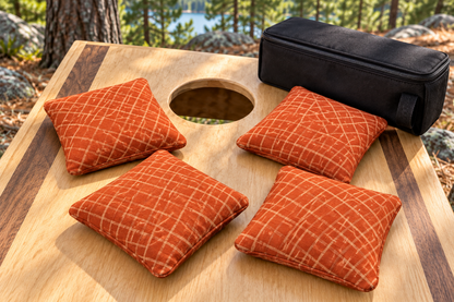 Four Spark Flow Inferno cornhole bags with matching patterned faces and black carrying case