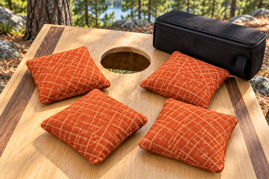 Four Spark Flow Inferno cornhole bags with matching patterned faces and black carrying case
